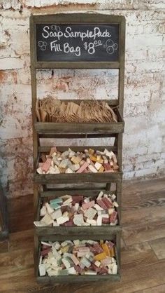 a wooden shelf filled with lots of different types of items next to a brick wall