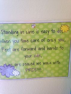 a sign posted on the wall saying standing in line is easy to do when you take care of only you, feet are forward and hands to your side