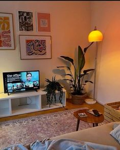 a living room filled with furniture and a flat screen tv sitting on top of a wooden table