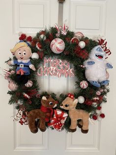 a christmas wreath with stuffed animals hanging from it