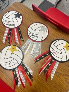 four volleyball trophy decorations on a table