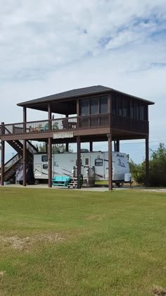 an rv park with a large deck and stairs leading up to it