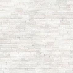 a white brick wall textured with light gray bricks