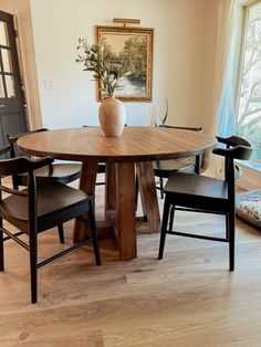 a wooden table with two chairs around it