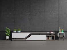 a modern white and black entertainment center with bookshelves, planters and chairs