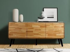 a sideboard with two vases on top of it