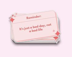 a pink reminder sticker that says it's just a bad day, not a bad life