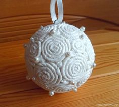 a white ornament hanging on a wooden table