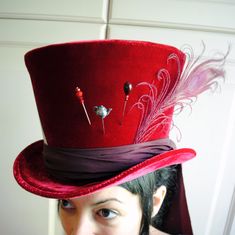 This striking Mad Hatter top hat is covered in a deep red velvet and decorated dark burgundy taffeta train, three hat pins, red peacock feather and the signature Mad Hatter price tag! Purchase this listing if you want exactly what you see or contact me if you need this top hat made in ANOTHER COLOR like green, blue, black, purple or whatever shade your heart desires This hat is fully lined with satin and it is made to according to your exact head measurement making it suitable for both men and w Wedding Top Hat, Mad Hatter Top Hat, Steampunk Top, Mad Hat, Steampunk Top Hat, Steampunk Halloween, Mad Hatter Hat, Veiled Hats, Hat Wedding