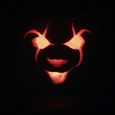 a carved pumpkin in the shape of a devil's head