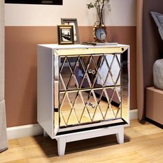 a mirrored cabinet in the corner of a room with a clock on it's side