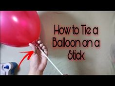 someone holding a red balloon with the words how to tie a balloon on a stick