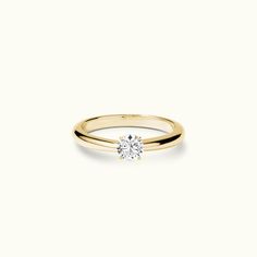 a yellow gold ring with a single diamond