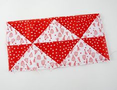 a red and white patchwork piece with hearts on it