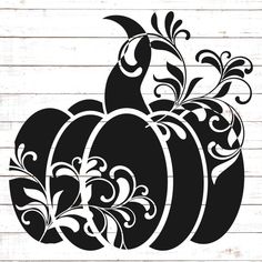 a black and white pumpkin stencil on a wooden background with an ornate design