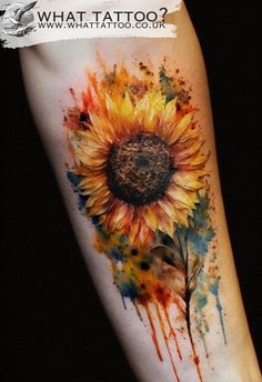 a sunflower with watercolor splashs on it's arm and the words what tattoo?