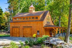 a large wooden garage surrounded by trees