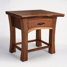 a small wooden table with one drawer on it