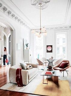 a living room filled with furniture and lots of windows