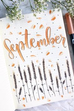 an open notebook with the word november written in cursive writing and some flowers