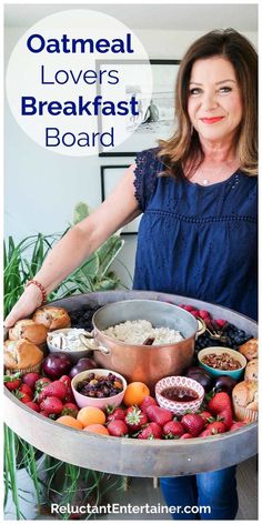 a woman standing in front of a large tray filled with lots of different types of food