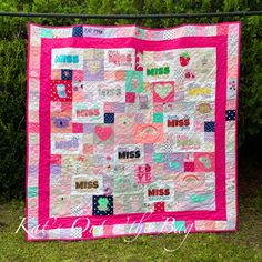 a pink and white quilt with words on it that read miss you, miss me