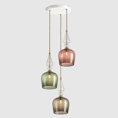 three different colored glass lights hanging from a ceiling