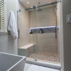 a bathroom with a walk in shower next to a bathtub