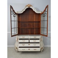 an antique dresser with mirrored doors and drawers in the shape of a bookcase is shown