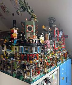 a very large display of legos and other toys on top of a blue cabinet