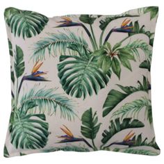 a white pillow with green and yellow tropical leaves on the front, and an orange bird of paradise on the back