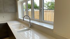 an empty kitchen counter with a sink and window