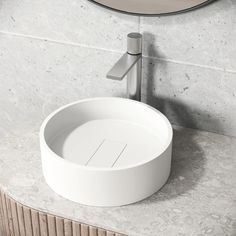 a white sink sitting on top of a marble counter