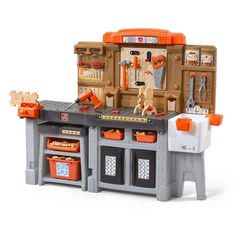 a toy kitchen with lots of tools on the counter and in it's storage area