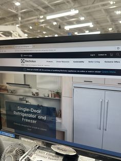 a computer screen displaying a website for kitchen cabinets and freezer refrigerators in a store