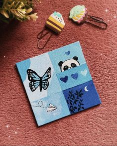 a piece of cloth with a panda bear and butterfly on it sitting next to other items