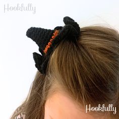 a close up of a child's head wearing a black crochet hair bow