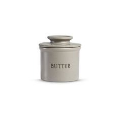 a white canister with the word butter on it's side and a metal lid