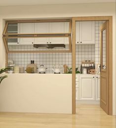 a kitchen with white cabinets and wooden floors