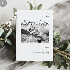 a white card with the words ellott and kate on it next to greenery