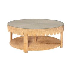 a round coffee table with scalloped edges and a glass top in natural wood