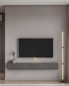 a flat screen tv mounted on the wall above a radiator in a living room