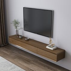 a flat screen tv mounted to the side of a wooden entertainment center in a living room