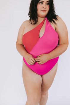 Beach-ready and beautiful in hot pink and red, our PLUS SIZE - Beach Bliss One Piece will have heads turning! With one shoulder-style and cheeky coverage, this one-piece swimsuit will make a splash! (And, of course, make you look FAB-ulous!) Details One-piece swimwear Removable padding Cheeky fit One shoulder Fully lined Sizing Approximate measurements: SIZE LENGTH BUST 1XL 29" 34” 2XL 30” 36" 3XL 31” 40” Fabric has stretch Model is 5’8” wearing 3XL Material 82% Polyester 18% SpandexHand wash co Bold Pink Swimwear For Summer, Bold Pink Swimwear For Pool, Bold Pink Summer Swimwear, Bold Fitted Pink Swimwear, Pink One-shoulder Swimwear For Pool, One-shoulder Pink Swimwear For Beach, Red One-shoulder Swimwear For Poolside, Plus Size One Piece Pink, Pink One-shoulder Swimwear