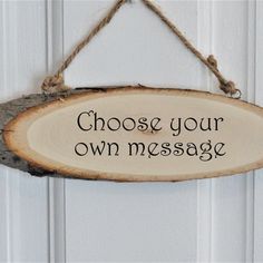 a sign that says choose your own message hanging on a door frame with twine