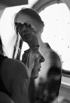 black and white photograph of two women looking at their cell phones in front of them