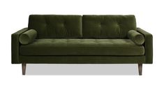 a green velvet couch with wooden legs and arm rests on an isolated white background,