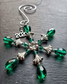 a cross made out of green glass beads