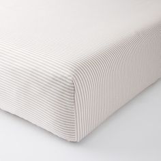 a close up view of a bed sheet with white stripes on the bottom and sides