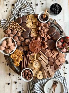 a table topped with lots of different types of food and desserts on top of it